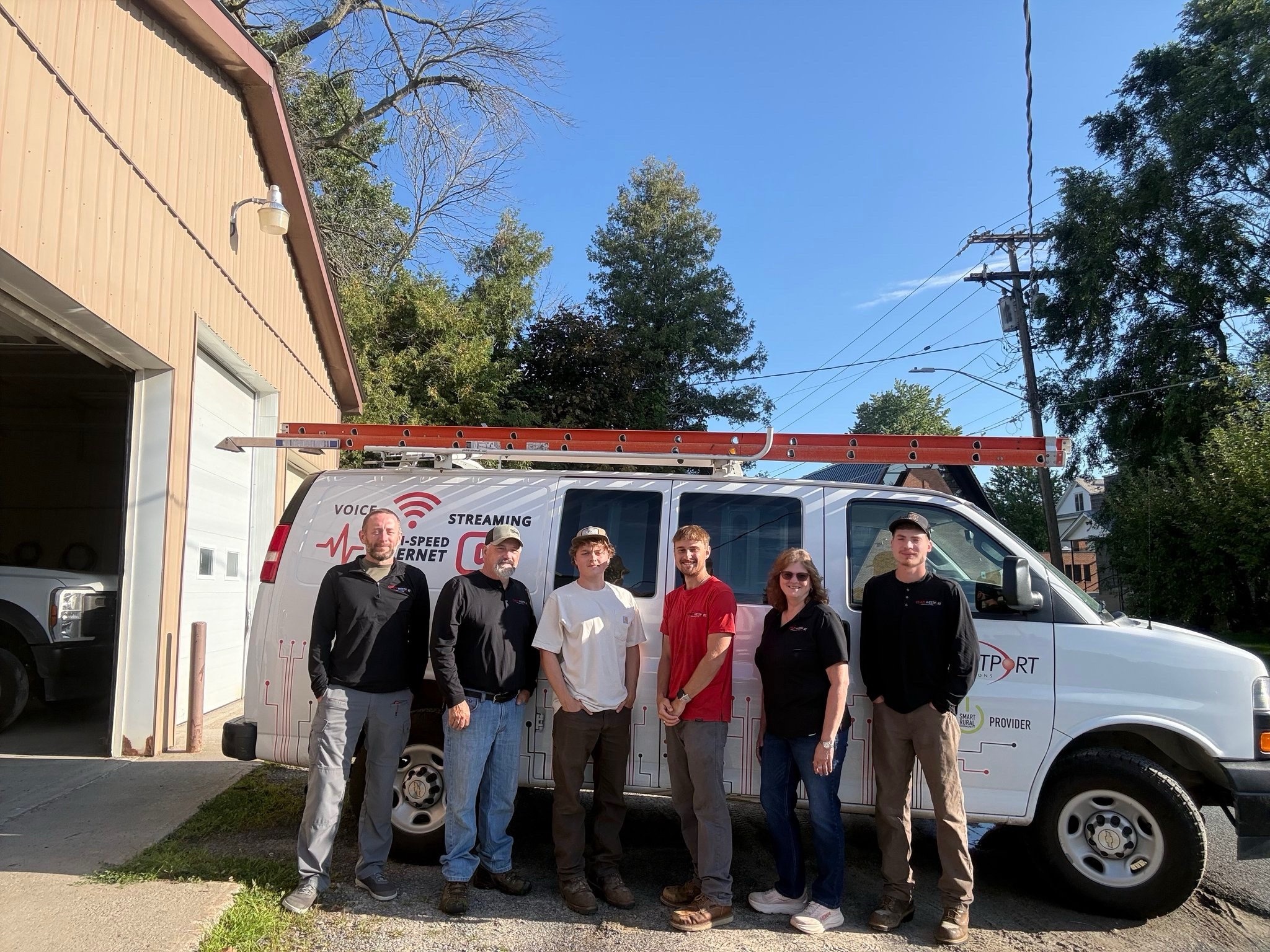C&W team standing beside a branded service van.