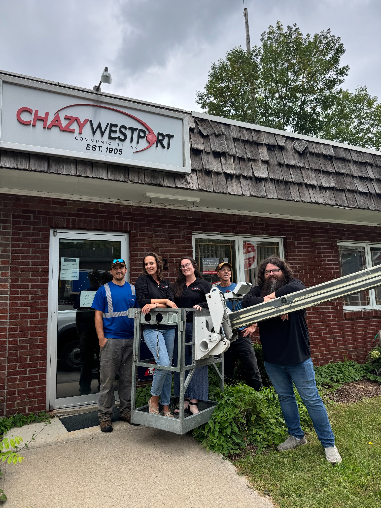 C&W team outside the office with a bucket truck.